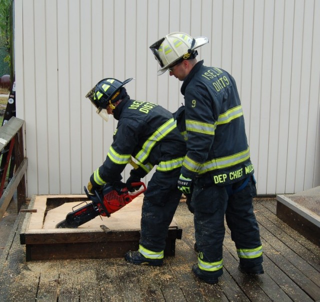 September 27, 2009: Probationary FF/EMT Perry Penna and Deputy Chief Ed Mullen try out the new Cutter's edge saw.